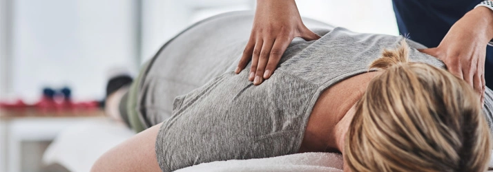 Chiropractic Rio Rancho NM Chiropractic Rio Rancho NM Hero Relief Blonde woman lying down receiving a back massage.
