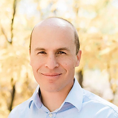 Dr. Jacob Robinson portrait wearing a light blue shirt.